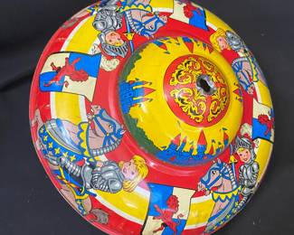 a vintage metal spinning top manufactured by the Ohio Art Company, featuring a colorful tin lithograph design depicting knights and castles