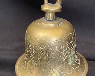 a vintage brass elephant bell, typically featuring intricate hand-engraved designs and often originates from India