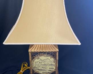 Chinoiserie-style table lamp featuring a gold-gilt, pagoda-shaped base decorated with a scenic painted village scene