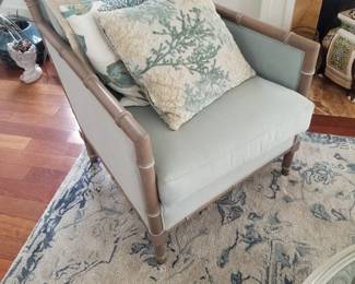 Elegant arm chair - two available; throw pillows; area rug detail