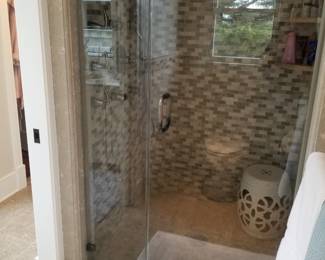 Glass shower door; shower hardware; ceramic gadren stool