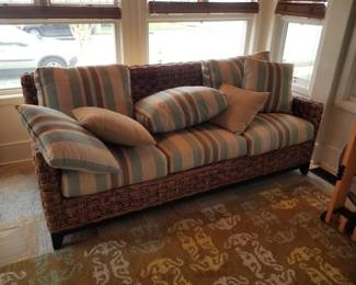 Lovely porch sofa; area rug