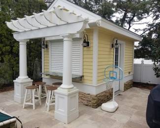 Pool house with electric hurricane shutter