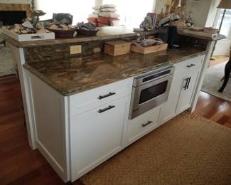 Kitchen island features VIKING drawer microwave oven