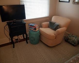 Cozy swivel chair; accent table; TV; ceramic garden stool