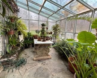 assorted plants and marble top table on base