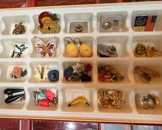 Vintage brooches and pin collection in tray