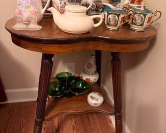 Antique oak parlor table with teapot collection display