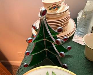 Stained glass Christmas tree with stacked Christmas china