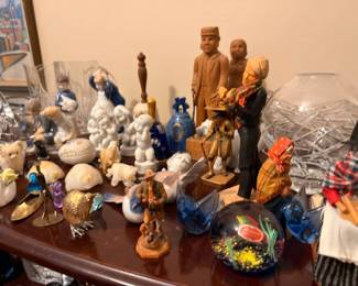 Porcelain figurines, carved wood folk art, and crystal paperweights