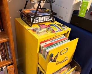 Yellow metal filing cabinet with files
