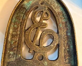 Antique brass sad iron trivet with scrollwork