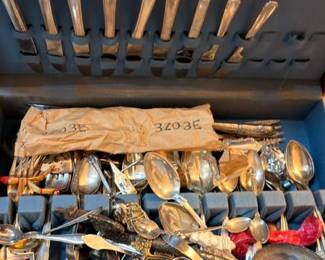 Assorted sterling and silver-plated flatware in chest