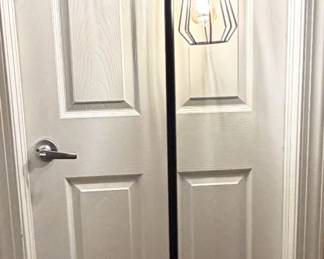 A modern, metal floor lamp.