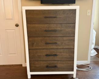 A queen bedroom set. Includes: Queen bed frame with built-in storage drawers, 1 nightstand, 2 dressers (one tall, one wide), with a Large matching mirror. Overall in excellent condition. Very clean, solid, and looks great in a room. Modern wood + white finish.