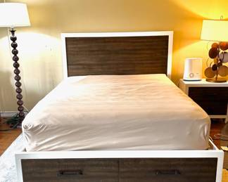 A queen bedroom set. Includes: Queen bed frame with built-in storage drawers, 1 nightstand, 2 dressers (one tall, one wide), with a Large matching mirror. Overall in excellent condition. Very clean, solid, and looks great in a room. Modern wood + white finish.