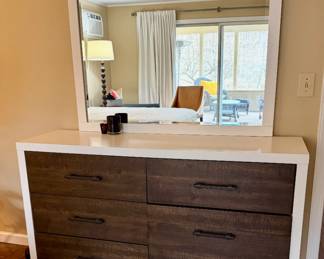 A queen bedroom set. Includes: Queen bed frame with built-in storage drawers, 1 nightstand, 2 dressers (one tall, one wide), with a Large matching mirror. Overall in excellent condition. Very clean, solid, and looks great in a room. Modern wood + white finish.
