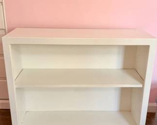 White Bookcase / Storage Shelf — Simple two-shelf unit, sturdy and functional, with some wear.