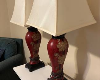 Pair of Chinese style table lamps in crimson red with off-white shades 