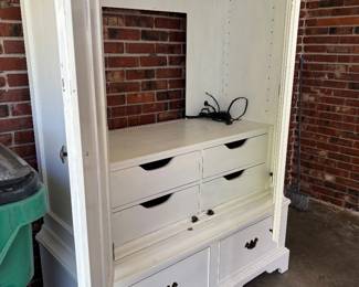 Large white entertainment center with cabinet doors and drawers for storage 