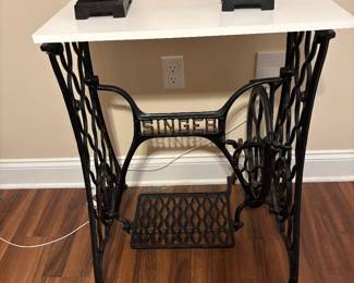 Collectible Vintage cast iron Singer sewing machine treadle base with a removable tabletop 