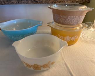 Several vintage Pyrex casserole dishes and bowls, Butterfly Gold. Amish Butterprint turquoise Cinderella bowl, Woodland brown casserole.  