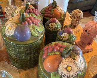 Adorable vintage 5 piece ceramic green canister set with fruit and flower decor lids.. smaller ones salt and pepper set