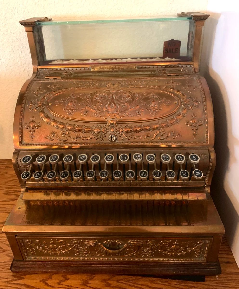 Antique ornate brass cash register manufactured by the National Cash Register Company (NCR) of Dayton, Ohi