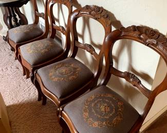 Four Victorian balloon-back dining chairs The Seats with needlepoint upholstery, commonly showcasing floral motifs mid-to-late 19th centurymid-to-late 19th century