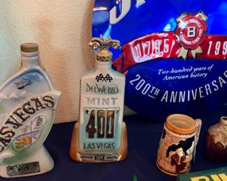 Produced by Regal China, this commemorative porcelain bottle was part of Jim Beam's "Customer Specialty" series. It features a raised-relief design showcasing Las Vegas landmarks and a helicopter. This commemorative porcelain piece was created for the 3rd annual Mint 400 Desert Rally in Las Vegas, sponsored by real estate developer Del Webb.