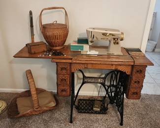 Treadle sewing machine cabinet with electric sewing machine inserted