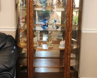 Curio cabinet with porcelain bird collection