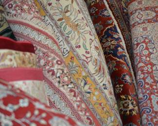 Large assortment of rugs from different regions