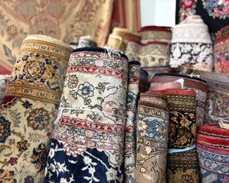 A wide range of rugs arranged side by side