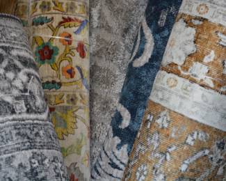 Stacks of rugs featuring traditional and modern designs