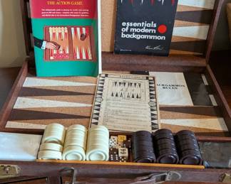 vintage Crisloid "Tournament" Backgammon Set, dating from the late 1960s or 1970s. Crisloid is one of the most respected names in the game, known for their cork-lined boards and high-quality "Catalin" (a type of heavy resin similar to Bakelite) checkers. The fact that yours includes the Prince Alexis Obolensky book and original paperwork makes it a complete "collector's set."