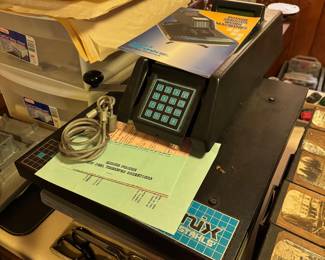 bottom of basement stairs to right