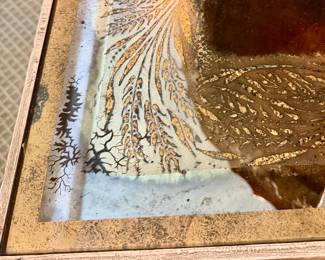 Interesting smoky mirror on the top of table.