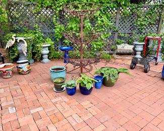 Sweet outdoor patio with French metal tiered plant stand