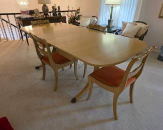 Beautiful Mid-Century dining table with 4 chairs. Has two leaves, protective pads and wings that fold down.  Excellent condition!
