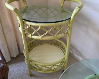 vintage rattan and glass bar cart, similar in style to mid-century modern or Hollywood Regency designs. 