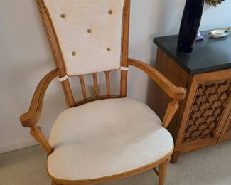 vintage high-back armchair featuring a light-colored upholstered seat and back