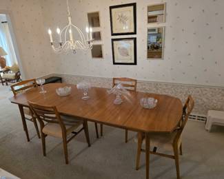Beautiful Mid-Century dining table with 4 chairs. Has three leaves and wings that fold down.  Excellent condition!