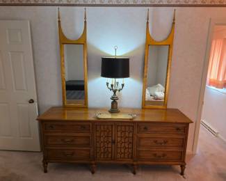 heritage furniture, Mid-Century Modern dresser With Hollywood Regency style giltwood mirror featuring a long, lean design adorned with two finials.  