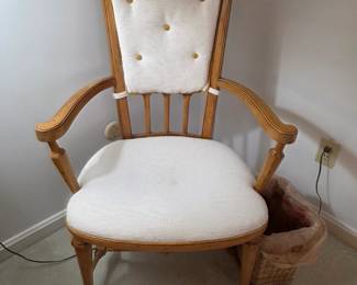 vintage high-back armchair featuring a light-colored upholstered seat and back