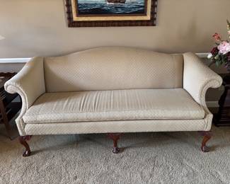 Camelback settee with carved claw and ball legs