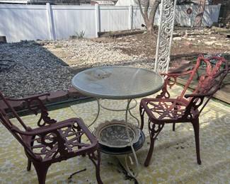 OUTDOOR TABLE AND CAST IRON CHAIRS