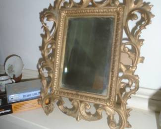 Beveled glass mirror in cast iron frame