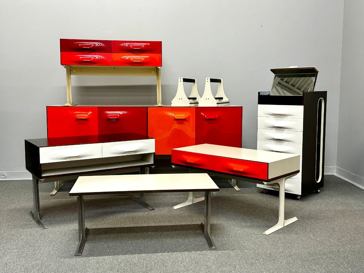 A phenomenal and rare collection of Raymond Loewy "DF2000" series furniture by famed 20th century industrial designer Raymond Loewy for Doubinsky Freres. Loewy's Compagnie de L’Esthetique Industrielle (CEI) in Paris created the design of the DF 2000 modern furniture line, which was then manufactured by Doubinsky Frères and sold in the United States beginning in 1968. These iconic pieces were only manufactured until the early 1970s. Pieces include the portable valet cabinet, an two-sided, eight-door buffet or room divider cabinet, a two-drawer console, and more! 