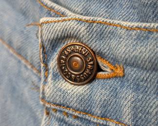 Closeup of pair of Levi jeans, faded blue denim